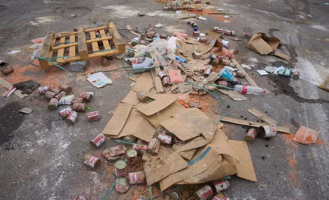 Damaged humanitarian aid for Palestinians in Gaza are scattered on the ground next to the border with the Gaza Strip near the Kissufim crossing in southern Israel, Wednesday, Aug. 13, 2025. (AP Photo/Ariel Schalit)