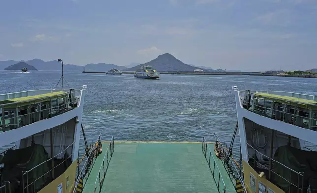 Ninoshima, an island where thousands of the dead and dying were brought after the first atomic bomb detonated 80 years ago, is seen from a ferry on Monday, July 7, 2025, in Hiroshima, western Japan. (AP Photo/Eugene Hoshiko)