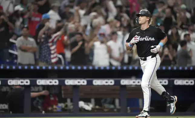 Miami Marlins' Kyle Stowers runs the bases after hitting a grand slam in the seventh inning of a baseball game against the New York Yankees, Friday, Aug. 1, 2025, in Miami. (AP Photo/Rebecca Blackwell)