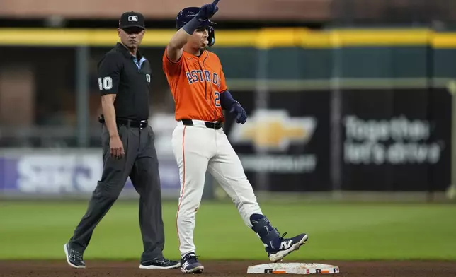 Houston Astros Ramón Urías celebrates after a single, and then advancing to second on a throwing error by Baltimore Orioles starting pitcher Brandon Young during the eighth inning of a baseball game in Houston, Friday, Aug. 15, 2025. (AP Photo/Ashley Landis)