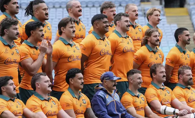 Australian players all wear fake moustaches as a tribute to retiring teammate Australia's Nic White, third from bottom right, as they pose for a photo before their captain's run training session in Sydney, Australia, Friday, Aug. 1, 2025, ahead of the rugby union test match against the British &amp; Irish Lions, Saturday. (AP Photo/Rick Rycroft)