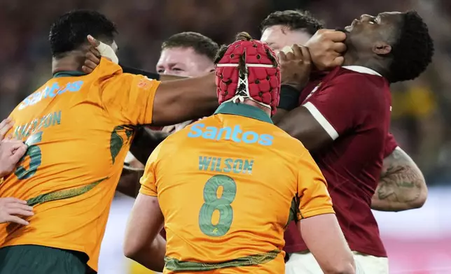 Maro Itoje of the British &amp; Irish Lions, right, and Australia's Will Skelton clash during the second rugby union test at the Melbourne Cricket Ground in Melbourne, Australia, Saturday, July 26, 2025. (AP Photo/Rick Rycroft)