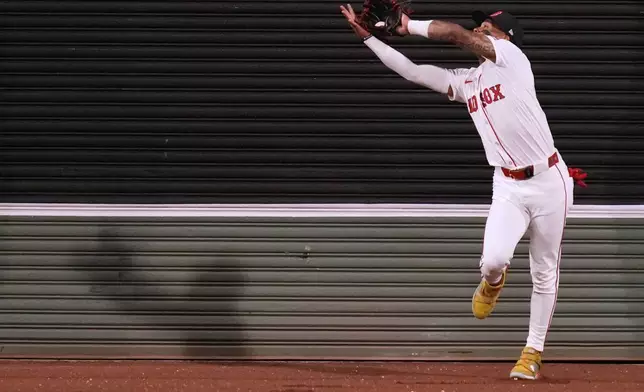 Boston Red Sox outfielder Ceddanne Rafaela catches a flyout hit by Baltimore Orioles' Ryan Mountcastle during the fifth inning of a baseball game at Fenway Park, Monday, Aug. 18, 2025, in Boston. (AP Photo/Charles Krupa)