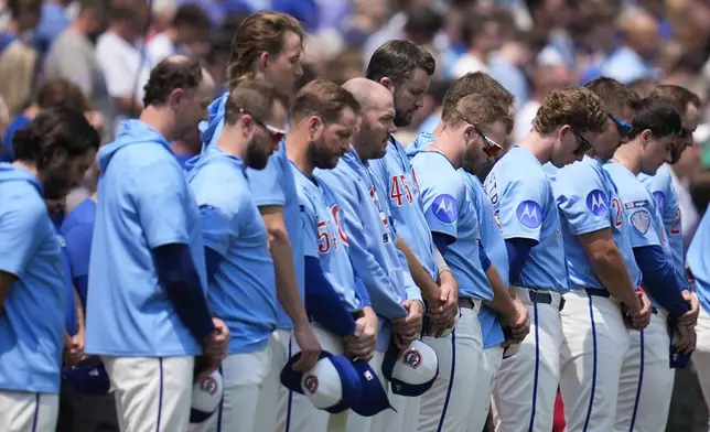 The Chicago Cubs stand for a 23-second moment of silence as former Cubs player Ryne Sandberg, who passed away from cancer in July, is honored before a baseball game against the Baltimore Orioles, Friday, Aug. 1, 2025, in Chicago. (AP Photo/Erin Hooley)