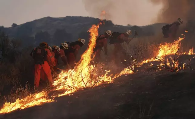 A California Department of Corrections fire crew battles the Canyon Fire on Thursday, Aug. 7, 2025, in Halsey Canyon, Calif. (AP Photo/Marcio Jose Sanchez)