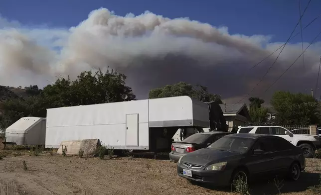 Smoke rises from the Canyon Fire on Thursday, Aug. 7, 2025, in Val Verde, Calif. (AP Photo/Marcio Jose Sanchez)