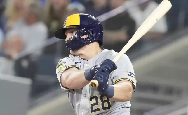 Milwaukee Brewers' Andrew Vaughn (28) hits an RBI single against the Toronto Blue Jays during the sixth inning of a baseball game in Toronto on Friday, August 29, 2025. (Chris Young/The Canadian Press via AP)