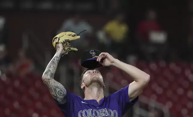 Colorado Rockies starting pitcher Kyle Freeland adjusts hit cap during the seventh inning of a baseball game against the St. Louis Cardinals Tuesday, Aug. 12, 2025, in St. Louis. (AP Photo/Jeff Roberson)
