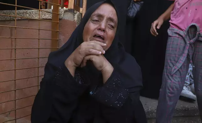 A Palestinian woman mourns her relative, who was killed along with others in Israeli strikes, during their funeral outside Nasser Hospital in Khan Younis, southern Gaza Strip, Saturday, Aug. 23, 2025. (AP Photo/Mariam Dagga)