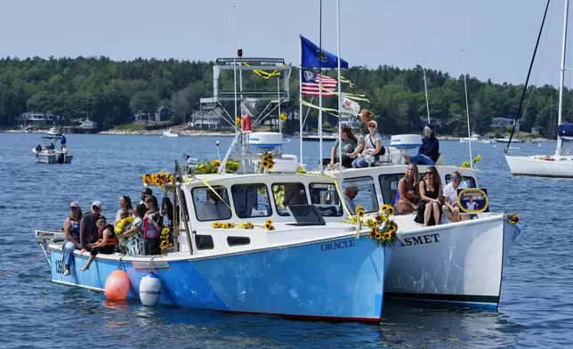 Friends and family attend a memorial service for Sunshine Stewart, Sunday, Aug. 10, 2025, off the coast of St. George, Maine. (AP Photo/Robert F. Bukaty)