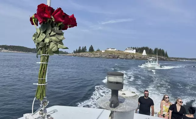 Roses decorate a lobster boat during a memorial service Sunshine Stewart, a former sternman, Sunday, Aug. 10, 2025, off the coast of St. George, Maine. (AP Photo/Robert F. Bukaty)