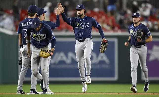 Tampa Bay Rays' Everson Pereira, center, and others celebrate after a baseball game against the Washington Nationals, Friday, Aug. 29, 2025, in Washington. (AP Photo/Nick Wass)