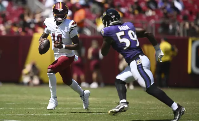 Washington Commanders quarterback Josh Johnson (14) scrambles as Baltimore Ravens outside linebacker Malik Hamm (59) defends during the second half of a preseason NFL football game Saturday, Aug. 23, 2025, in Landover, Md. (AP Photo/Nick Wass)