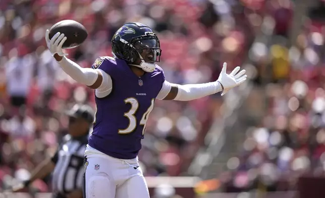 Baltimore Ravens cornerback Thomas Graham Jr. celebrates after intercepting a pass during the second half of a preseason NFL football game Saturday, Aug. 23, 2025, in Landover, Md. (AP Photo/Stephanie Scarbrough)
