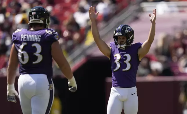 Baltimore Ravens kicker Tyler Loop celebrates after making a 61-yard field goal as guard Jared Penning (63) watches during the second half of a preseason NFL football game against the Washington Commanders Saturday, Aug. 23, 2025, in Landover, Md. (AP Photo/Stephanie Scarbrough)
