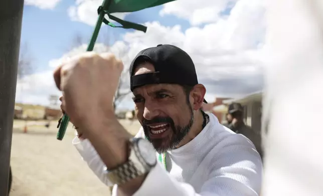 Opposition leader Luis Fernando Camacho, the suspended governor of Santa Cruz, holds up his fist and the Santa Cruz flag as he is released from jail and allowed house arrest after almost three years in pretrial detention for his involvement in violent unrest that led to the 2019 ouster of then-President Evo Morales, in La Paz, Bolivia, Friday, Aug. 29, 2025. (AP Photo/Gaston Brito)