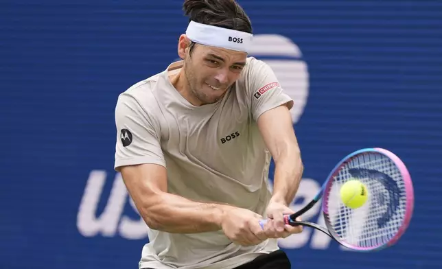 Taylor Fritz, of the United States, returns a shot to Emilio Nava, of the United States, during the first round of the US Open tennis championships, Sunday, Aug. 24, 2025, in New York. (AP Photo/Yuki Iwamura)