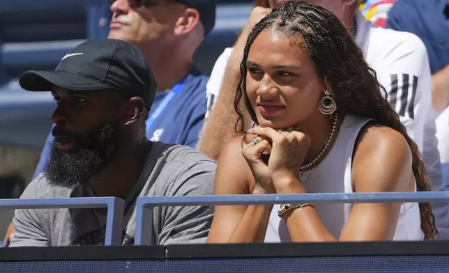 U.S. women's national team soccer player Trinity Rodman, right, watches Ben Shelton play against Ignacio Buse, of Peru, during the first round of the US Open tennis championships, Sunday, Aug. 24, 2025, in New York. (AP Photo/Kirsty Wigglesworth)