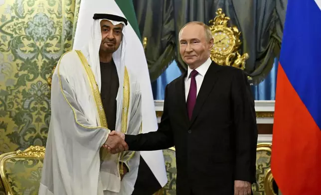 Russian President Vladimir Putin, right, and United Arab Emirates President Sheikh Mohammed bin Zayed Al Nahyan shake hands during their meeting at the Grand Kremlin Palace in Moscow, Russia, Thursday, Aug. 7, 2025. (Alexander Nemenov/Pool Photo via AP)