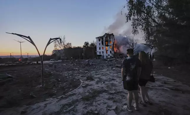 Locals look at a residential house destroyed by a Russian air strike in Kramatorsk, Ukraine, on Thursday, July 31, 2025. (AP Photo/Yevhen Titov)