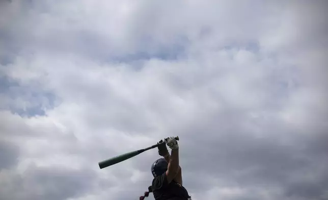 A player warms up during the third day of tryouts for the Women's Professional Baseball League, Sunday, Aug. 24, 2025, at the Washington Nationals Youth Baseball Academy in Washington. (AP Photo/Julia Demaree Nikhinson)