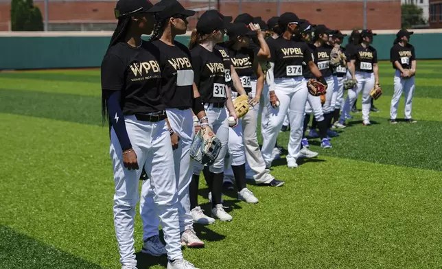 Mo'ne Davis, left, and other players wait in line on the field during the first day of tryouts for the Women's Professional Baseball League, Friday, Aug 22, 2025, at the Washington Nationals Youth Baseball Academy in Washington. (AP Photo/Julia Demaree Nikhinson)