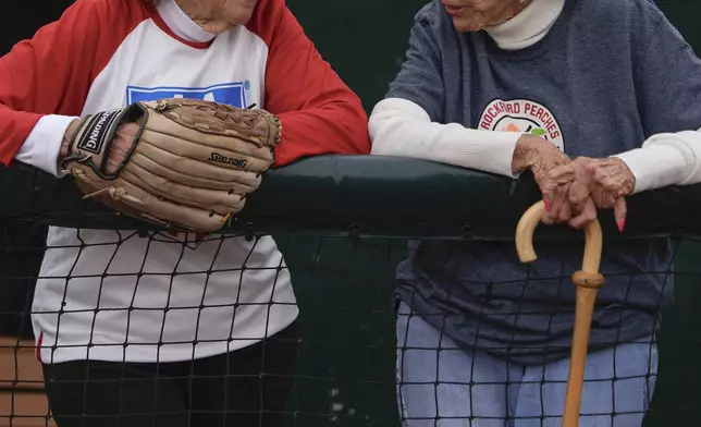 Jeneane Lesko, left, and Maybelle Blair, right, both players in the All-American Girls Professional Baseball League, watch the third day of tryouts for the Women's Professional Baseball League, Sunday, Aug. 24, 2025, at the Washington Nationals Youth Baseball Academy in Washington. (AP Photo/Julia Demaree Nikhinson)