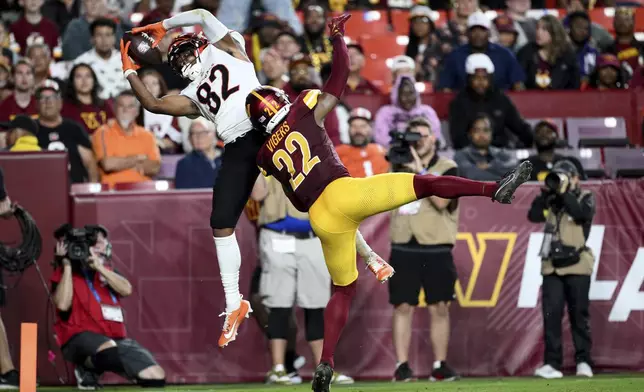 Cincinnati Bengals wide receiver Mitchell Tinsley (82) catches a touchdown pass as Washington Commanders cornerback Car'lin Vigers (22) defends during the first half of a preseason NFL football game Monday, Aug. 18, 2025, in Landover, Md. (AP Photo/Nick Wass)