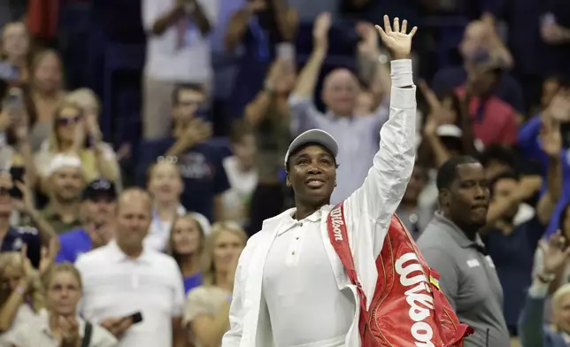 Venus Williams, of the United States, waves to fans after being defeated by Karolina Muchova, of the Czech Republic, during the first round of the U.S. Open tennis championships, Monday, Aug. 25, 2025, in New York. (AP Photo/Adam Hunger)