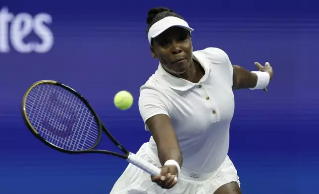 Venus Williams, of the United States, returns a shot to Karolina Muchova, of the Czech Republic, during the first round of the U.S. Open tennis championships, Monday, Aug. 25, 2025, in New York. (AP Photo/Adam Hunger)