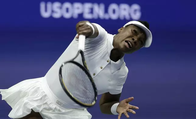 Venus Williams, of the United States, serves to Karolina Muchova, of the Czech Republic, during the first round of the U.S. Open tennis championships, Monday, Aug. 25, 2025, in New York. (AP Photo/Adam Hunger)