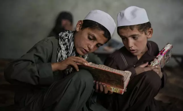 Afghan boys attend a Quran class at the Abdullah Ibn-Masoud religious school on the outskirts of Kabul, Afghanistan, Monday, May 26, 2025. (AP Photo/Ebrahim Noroozi)