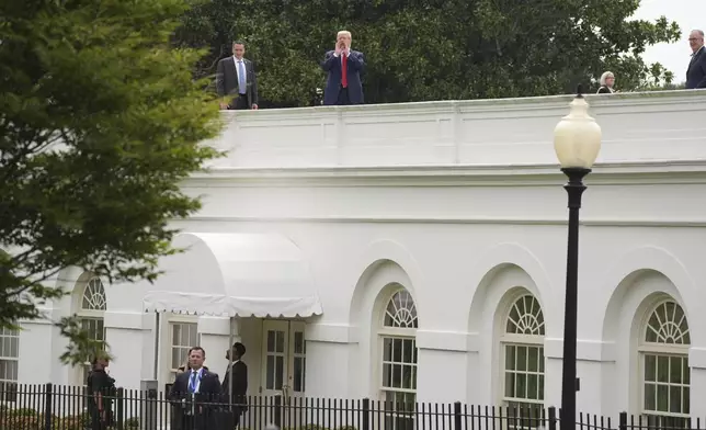 President Donald Trump walks on the roof of the White House briefing room, Tuesday, August 5, 2025, in Washington. (AP Photo/Evan Vucci)