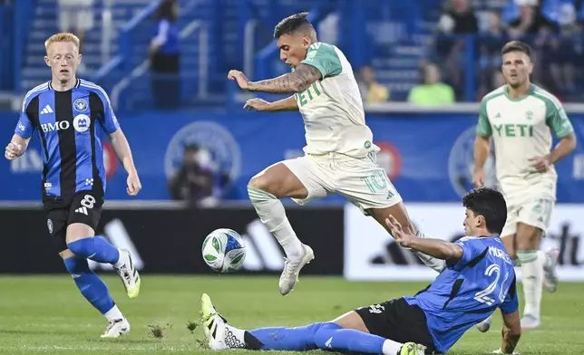 Austin FC's Myrto Uzuni (10) leaps over CF Montreal's Efrain Morales (24) during first-half MLS soccer match action in Montreal, Saturday, Aug. 23, 2025. (Graham Hughes/The Canadian Press via AP)