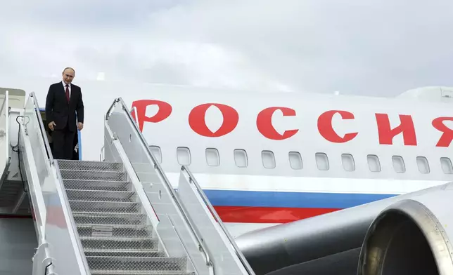 Russian President Vladimir Putin stands on the steps of the plane prior to departure at Joint Base Elmendorf-Richardson, Alaska, Friday, Aug. 15, 2025, after meeting with U.S. President Donald Trump. (Gavriil Grigorov, Sputnik, Kremlin Pool Photo via AP)