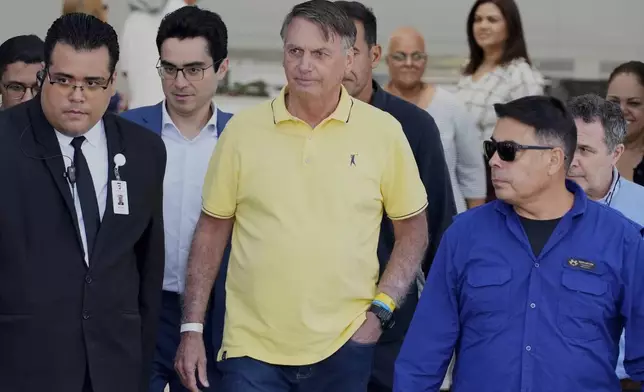 Brazil’s former President Jair Bolsonaro, center, temporarily allowed out of house arrest for medical exams, departs a hospital in Brasília, Brazil, Saturday, Aug. 16, 2025. (AP Photo/Eraldo Peres)