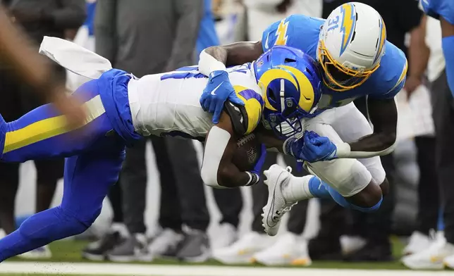 Los Angeles Rams wide receiver Brennan Presley, left, is tackled by Los Angeles Chargers safety Trikweze Bridges during the first half of an NFL preseason football game, Saturday, Aug. 16, 2025, in Inglewood, Calif. (AP Photo/Mark J. Terrill)