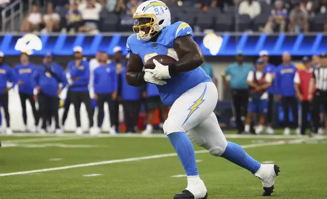 Los Angeles Chargers defensive tackle TeRah Edwards runs after intercepting a pass against the Los Angeles Rams during the second half of an NFL preseason football game, Saturday, Aug. 16, 2025, in Inglewood, Calif. (AP Photo/Jessie Alcheh)