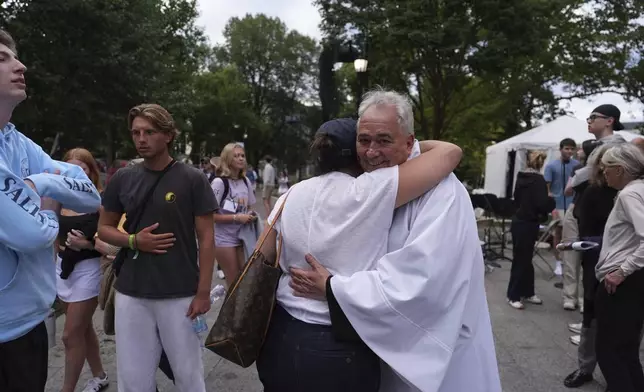 Villanova University President Father Peter M. Donohue comforts after an active shooter was reported Thursday, Aug. 21, 2025, in Villanova, Pa. (AP Photo/Matt Slocum)