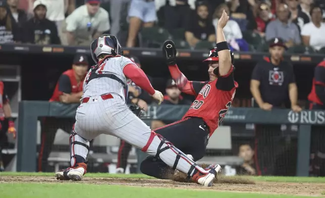 Minnesota Twins catcher Ryan Jeffers (27) tags out Chicago White Sox third baseman Miguel Vargas (20) during the eighth inning of a baseball game, Friday, Aug. 22, 2025, in Chicago. (AP Photo/Talia Sprague)
