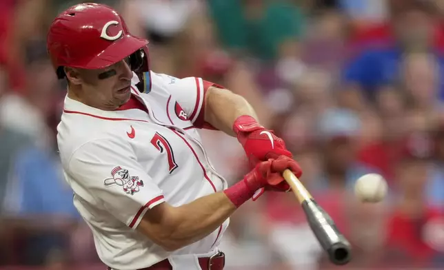 Cincinnati Reds' Spencer Steer hits a two-run double during the third inning of a baseball game against the Philadelphia Phillies Tuesday, Aug. 12, 2025, in Cincinnati. (AP Photo/Carolyn Kaster)