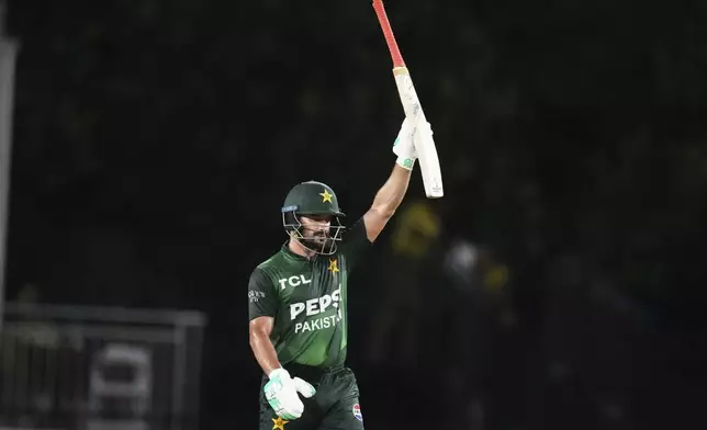 Pakistan's Sahibzada Farhan raises his bat after reaching a half century during the third Twenty20 cricket match against the West Indies, Sunday, Aug. 3, 2025, in Lauderhill, Fla. (AP Photo/Lynne Sladky)