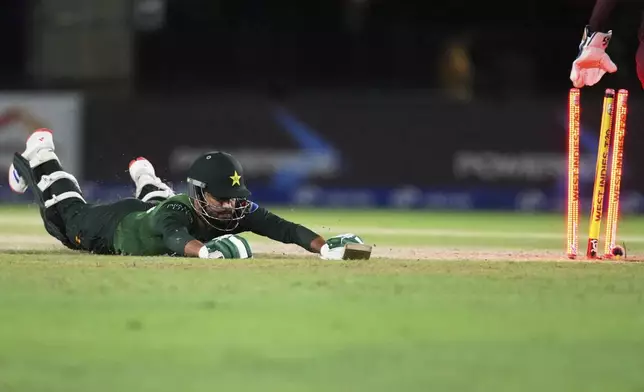 Pakistan's Mohammad Haris is run out during the third Twenty20 cricket match against the West Indies, Sunday, Aug. 3, 2025, in Lauderhill, Fla. (AP Photo/Lynne Sladky)