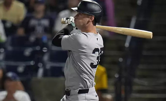 New York Yankees' Cody Bellinger watches his solo home run off Tampa Bay Rays pitcher Shane Baz during the first inning of a baseball game Tuesday, Aug. 19, 2025, in Tampa, Fla. (AP Photo/Chris O'Meara)