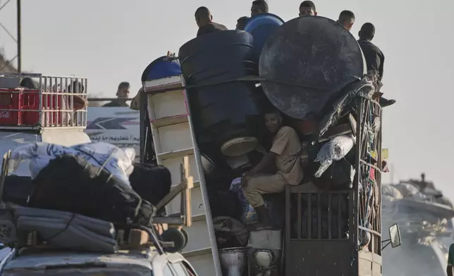 Displaced Palestinians fleeing northern Gaza Strip move with their belongings along the Sea Road, near Wadi Gaza, Saturday, Aug. 30, 2025. (AP Photo/Abdel Kareem Hana)