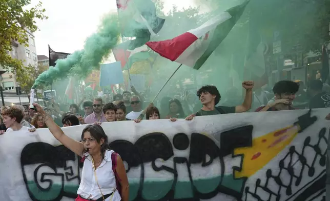 Demonstrators hold a banner that reads 'Genocide' during a march in support of the Palestinian people in Gaza, during the Film Festival in Venice, Italy, Saturday, Aug. 30, 2025. (Photo by Alessandra Tarantino/Invision/AP)