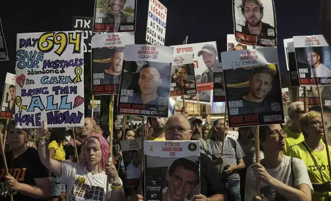 People attend a rally demanding the immediate release of all hostages held by Hamas and calling for an end of the war in the Gaza Strip, at a plaza known as the hostages square in Tel Aviv, Israel, Saturday, Aug. 30, 2025. (AP Photo/Mahmoud Illean)