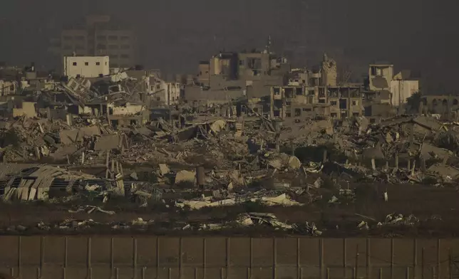 Buildings that were destroyed during the Israeli ground and air operations stand in the northern Gaza Strip as seen from southern Israel, Saturday, Aug. 30, 2025. (AP Photo/Leo Correa)