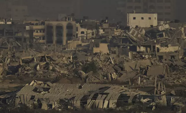 Buildings that were destroyed during the Israeli ground and air operations stand in the northern Gaza Strip as seen from southern Israel, Saturday, Aug. 30, 2025. (AP Photo/Leo Correa)