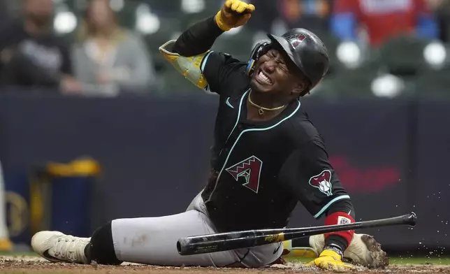 Arizona Diamondbacks' Geraldo Perdomo reacts after being hit by a pitch during the fifth inning of a baseball game against the Milwaukee Brewers, Monday, Aug. 25, 2025, in Milwaukee. (AP Photo/Aaron Gash)